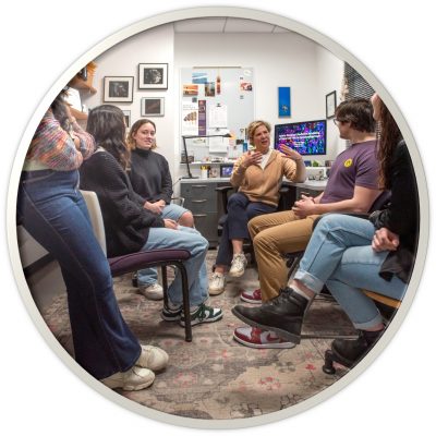 Group of students meeting with their professor