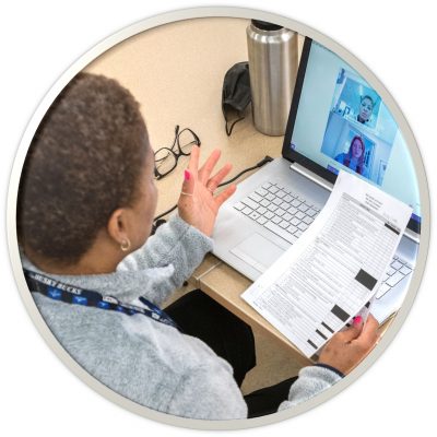 Someone in a web-meeting, holding a piece of paper